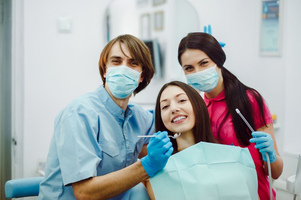 Happy Dentists With Patient